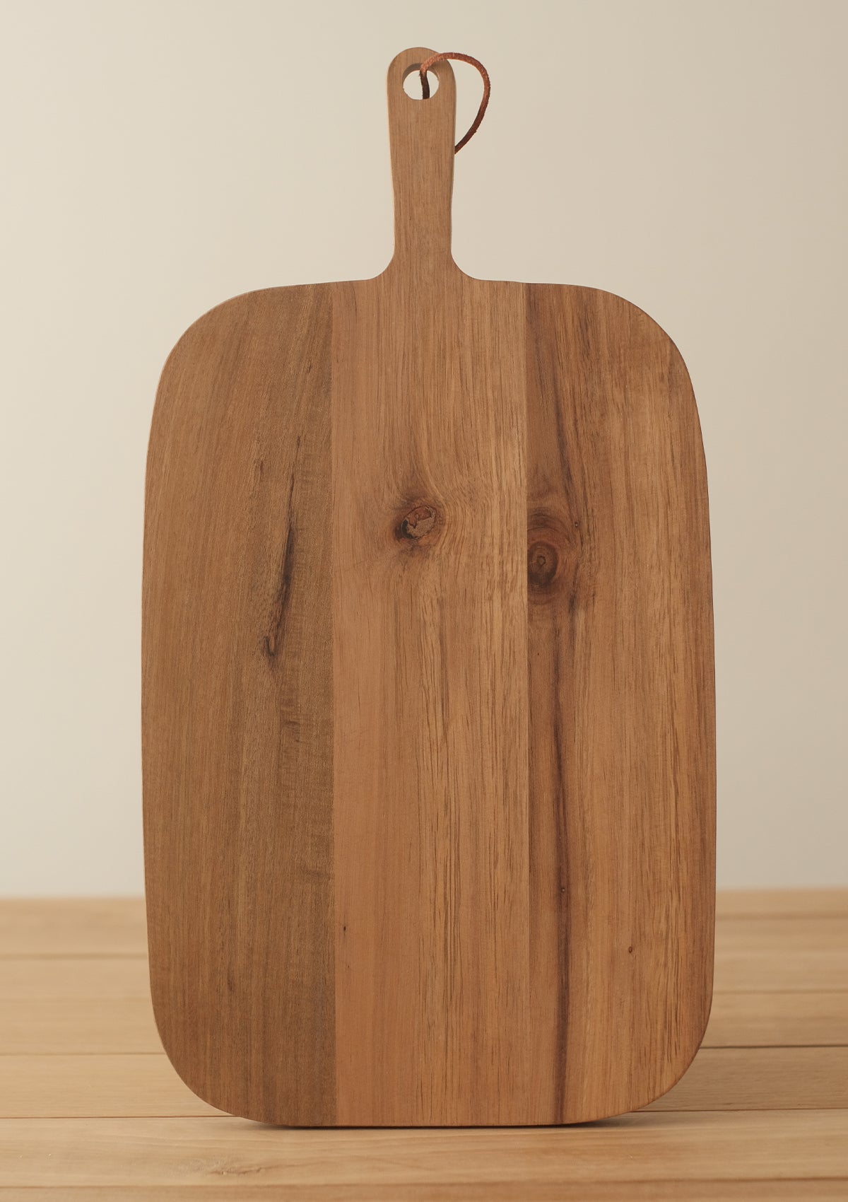 The Alaric Serving Board has a handle for easy serving and a leather strap to display the board.
