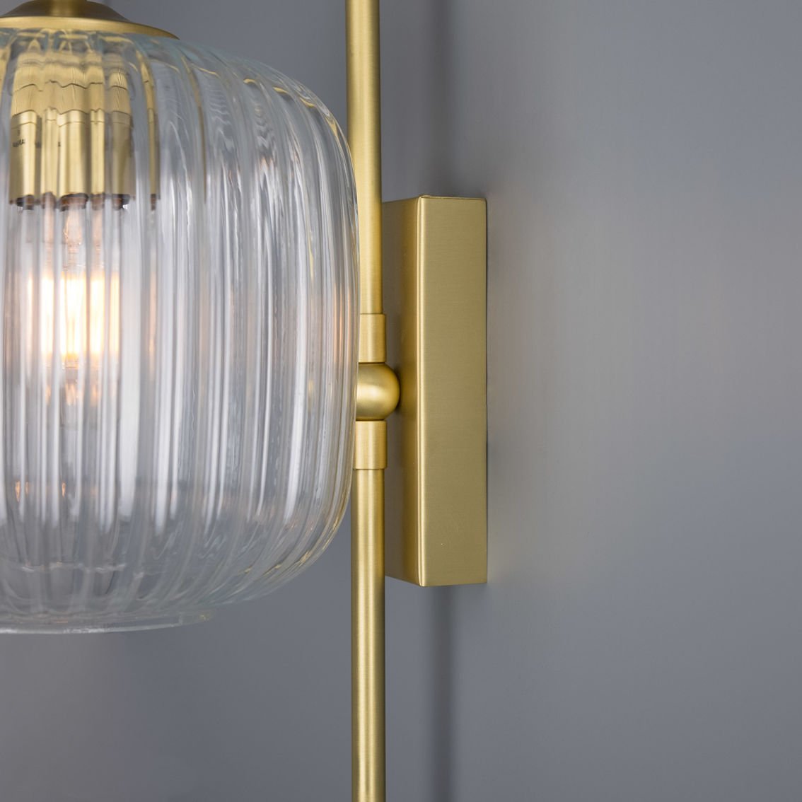 The Astoria wall light has a brass base and arm that comes in four colour finish options.