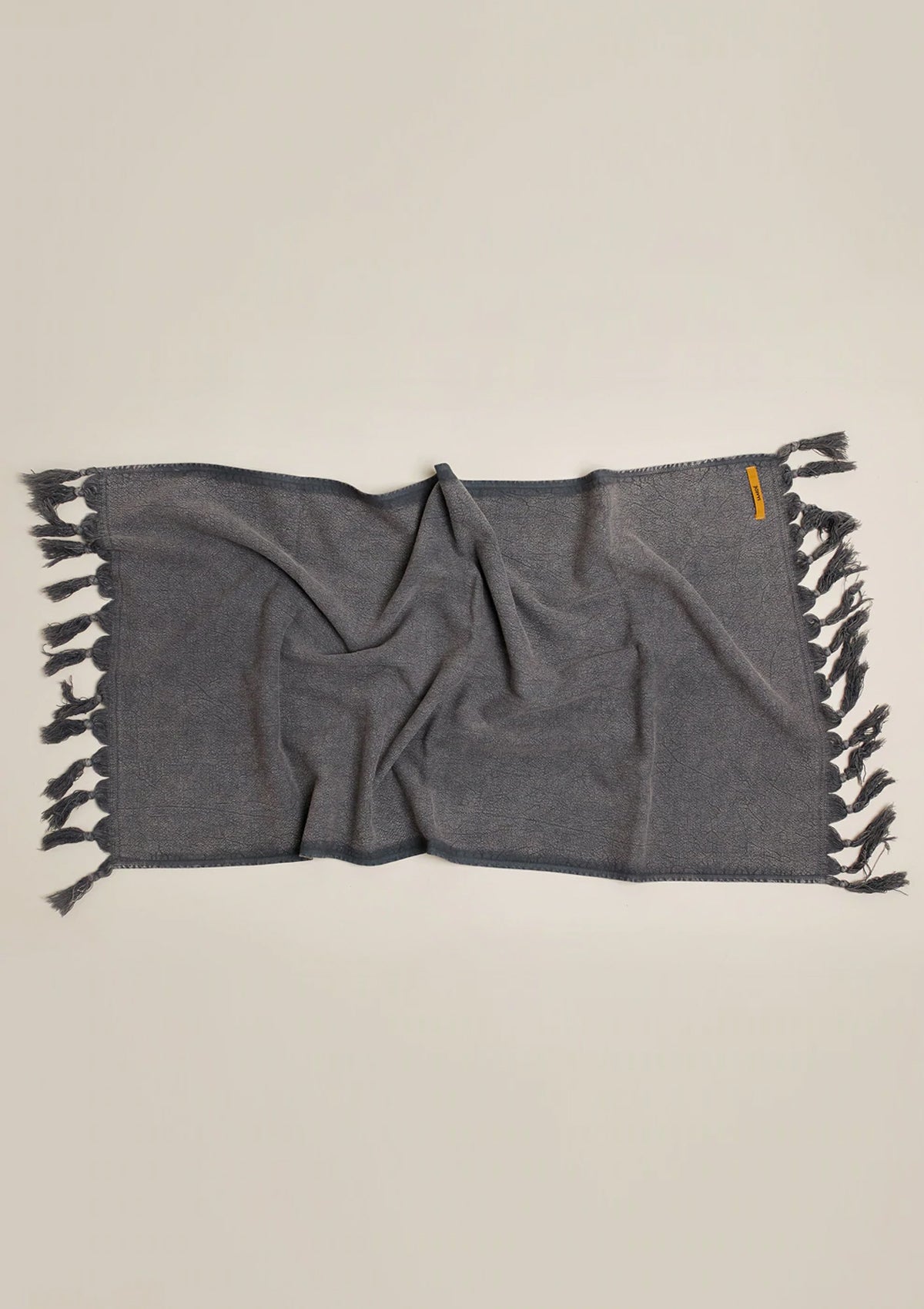 This Vintage Wash Hand Towel comes in a worn charcoal and is made of soft cotton.