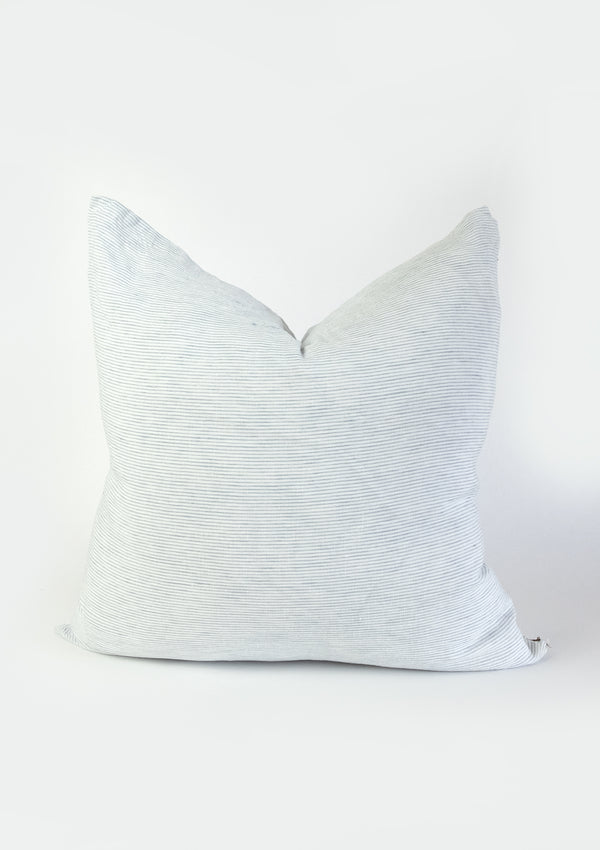 The Adora Pillow Cover in Sky is a linen pillow with pale blue and white tones. 