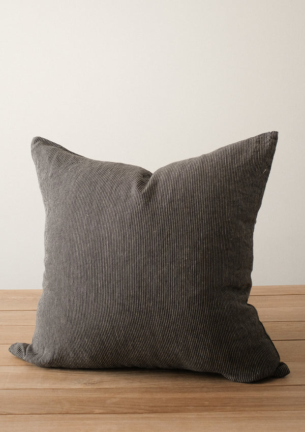 The Adora Pillow cover comes in the colour charcoal and is made of soft linen. 