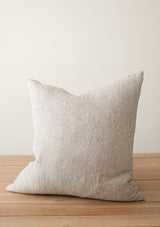 The Adora Pillow Cover in White and Chocolate has warm brown and white tones. 