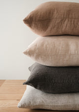 The Adora Pillow Cover is made from soft linen and has a ribbed texture.