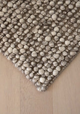 The Ambergris rug is hand woven from wool and viscose. 