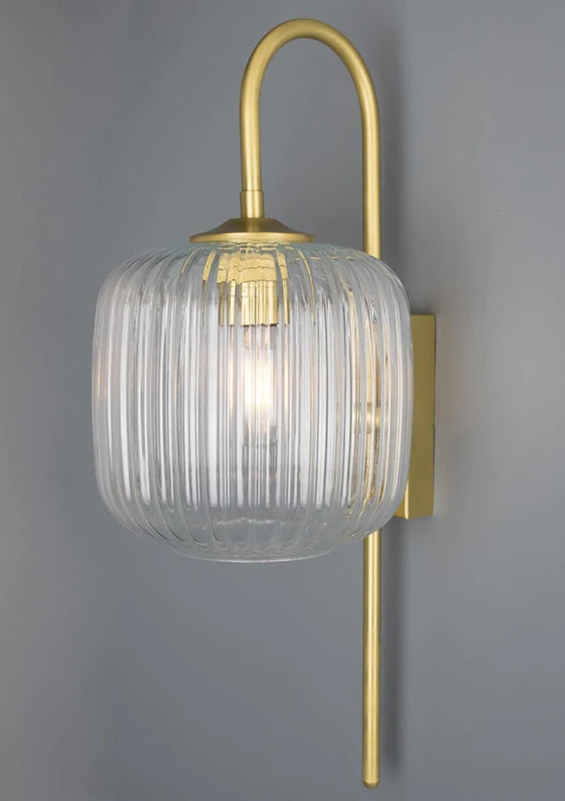 The Astoria wall light has a reeded glass shade.
