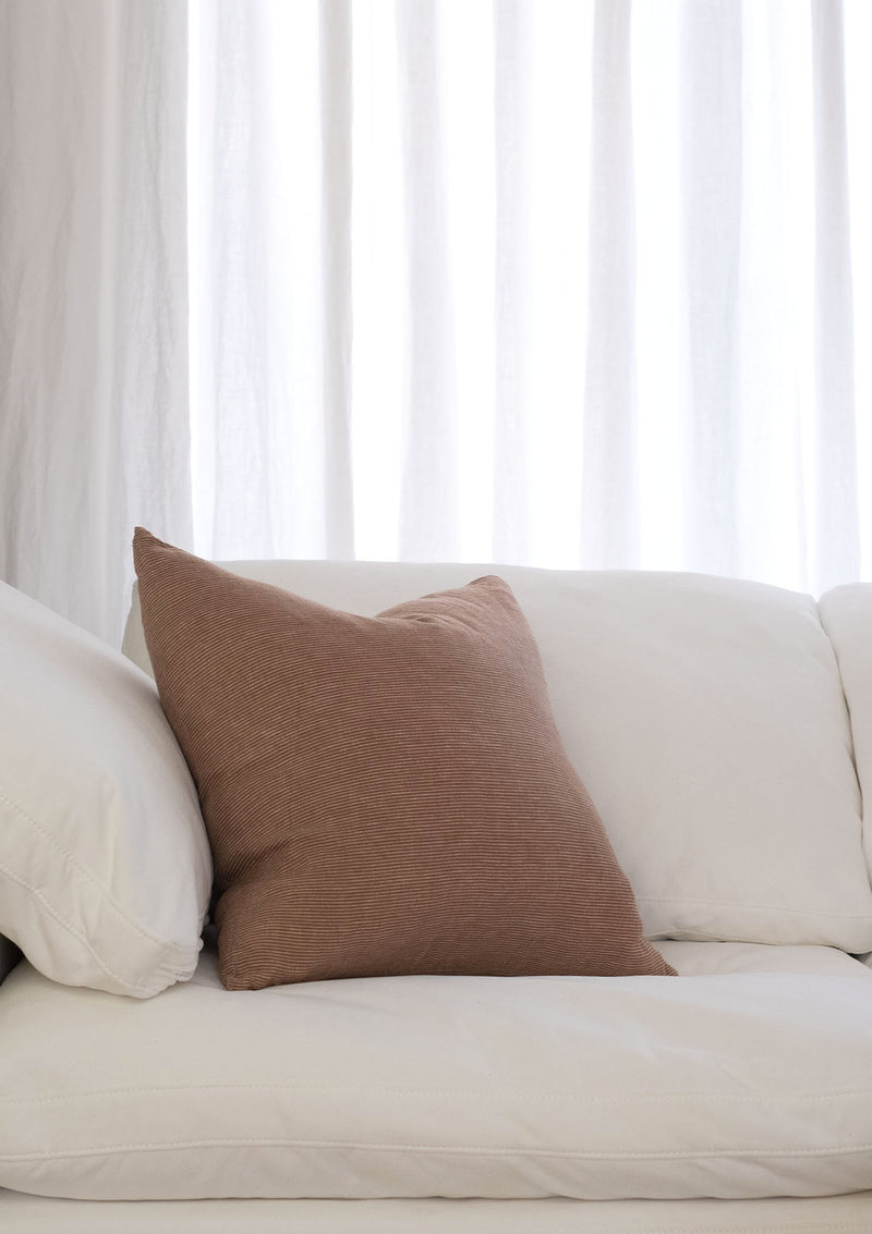 The Adora Pillow Cover is a square linen pillow cover measuring 19.5 in by 19.5 in.