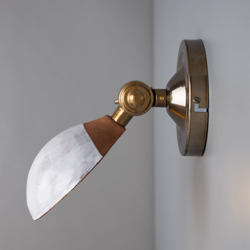 The Coco ceramic wall  light has a terracotta shade with a white glaze. 