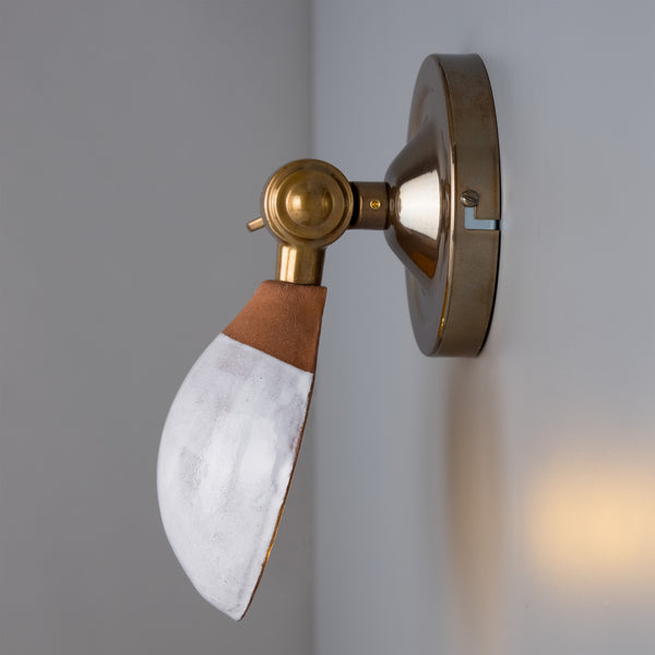 The Coco Wall Light has a brass adjustable arm to move the light up and down. 