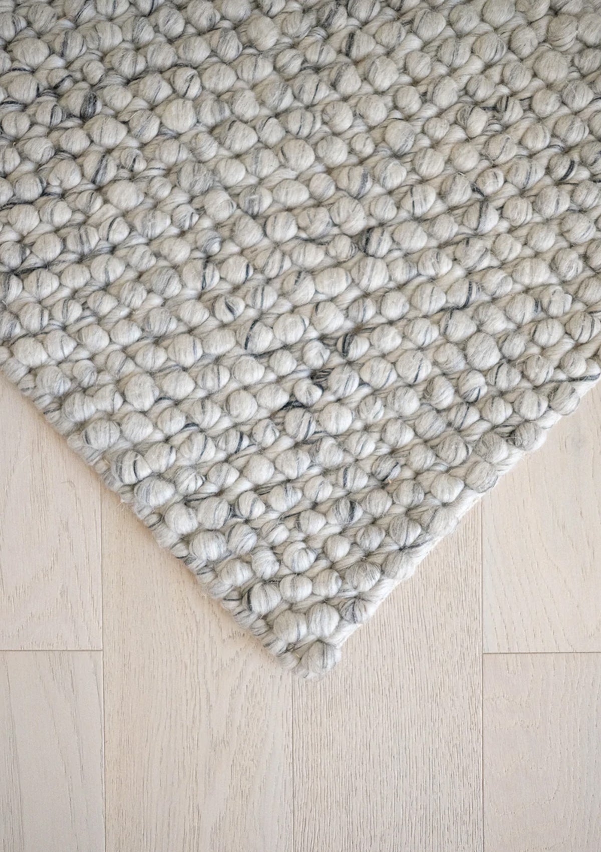 The Lark Rug is hand woven and is made of 60% Wool, and 40% Polyester.