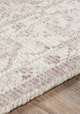 The Lauren Rug is a little under half an inch thick and has a braided edge.